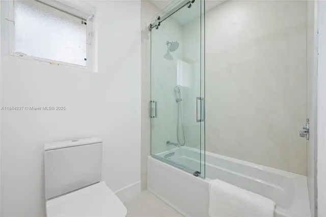 a bathroom with a shower and toilet