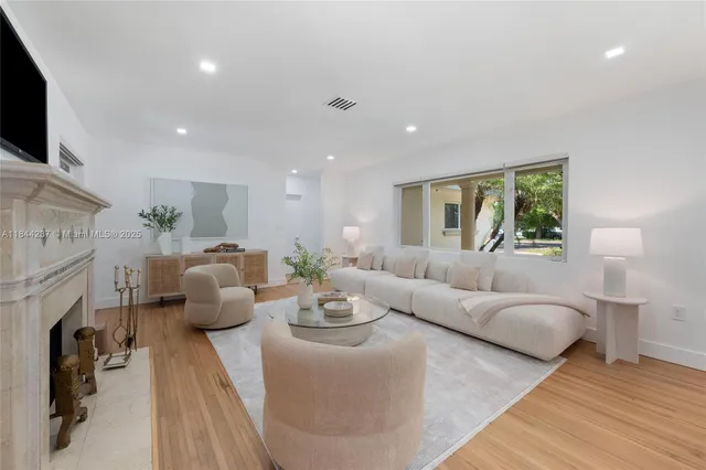 a living room with fireplace furniture and a flat screen tv
