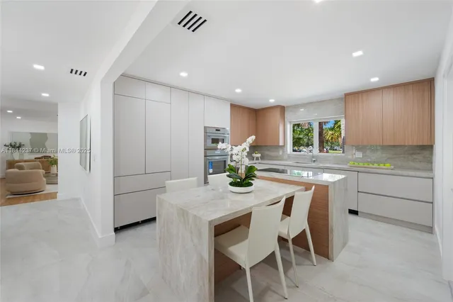 a kitchen with kitchen island granite countertop wooden cabinets and counter space