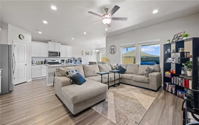 a living room with furniture and kitchen view