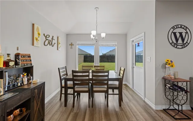 a view of a dining room with furniture kitchen and wooden floor