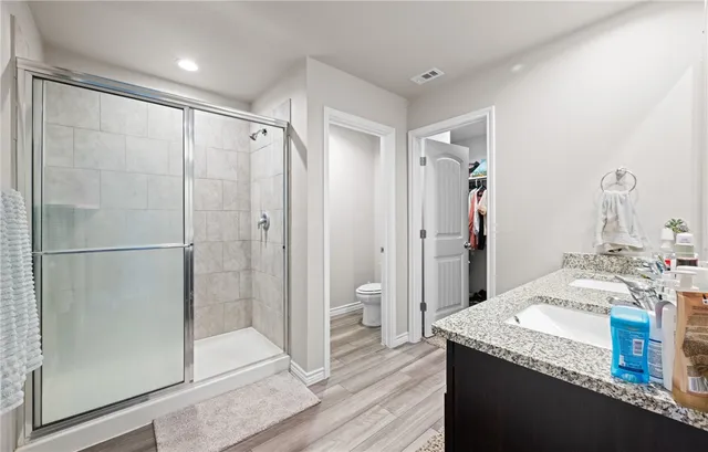 a bathroom with a granite countertop shower sink and mirror