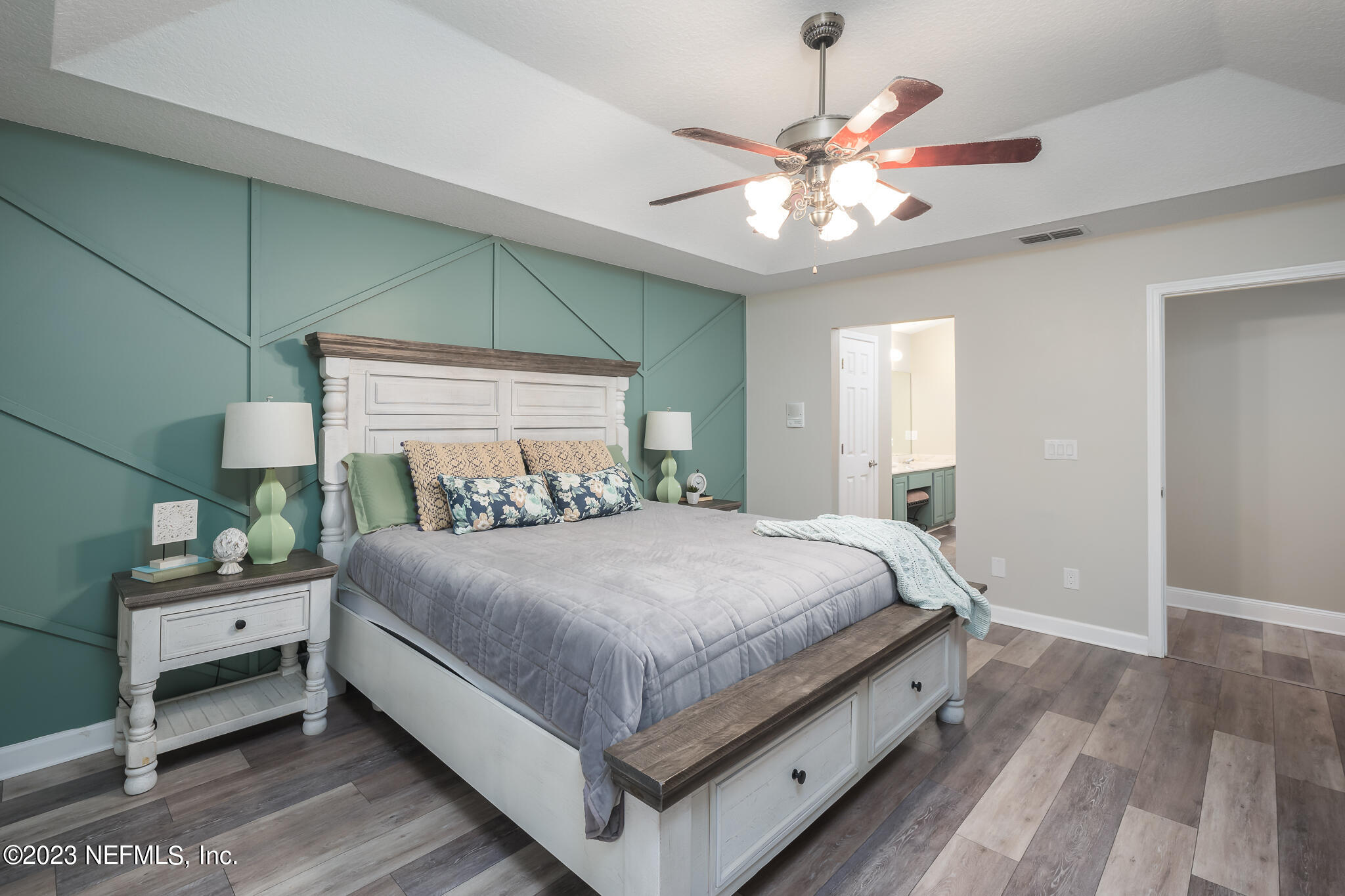775 Camp Francis Johnson Road Orange Park, FL 32065 - Photo 22 of 41 a bedroom with a bed and a chandelier