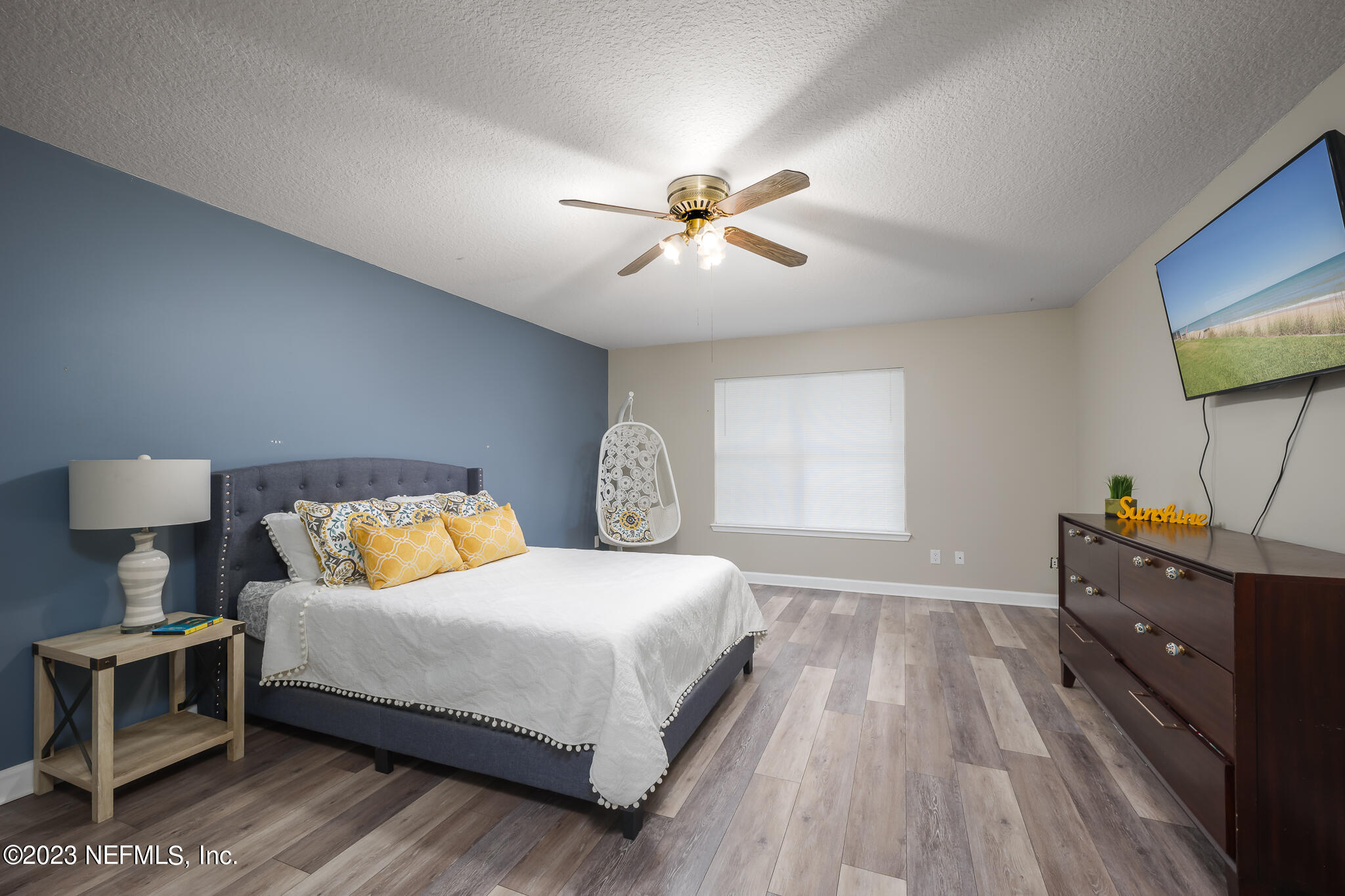 775 Camp Francis Johnson Road Orange Park, FL 32065 - Photo 31 of 41 a bedroom with a bed and a chandelier