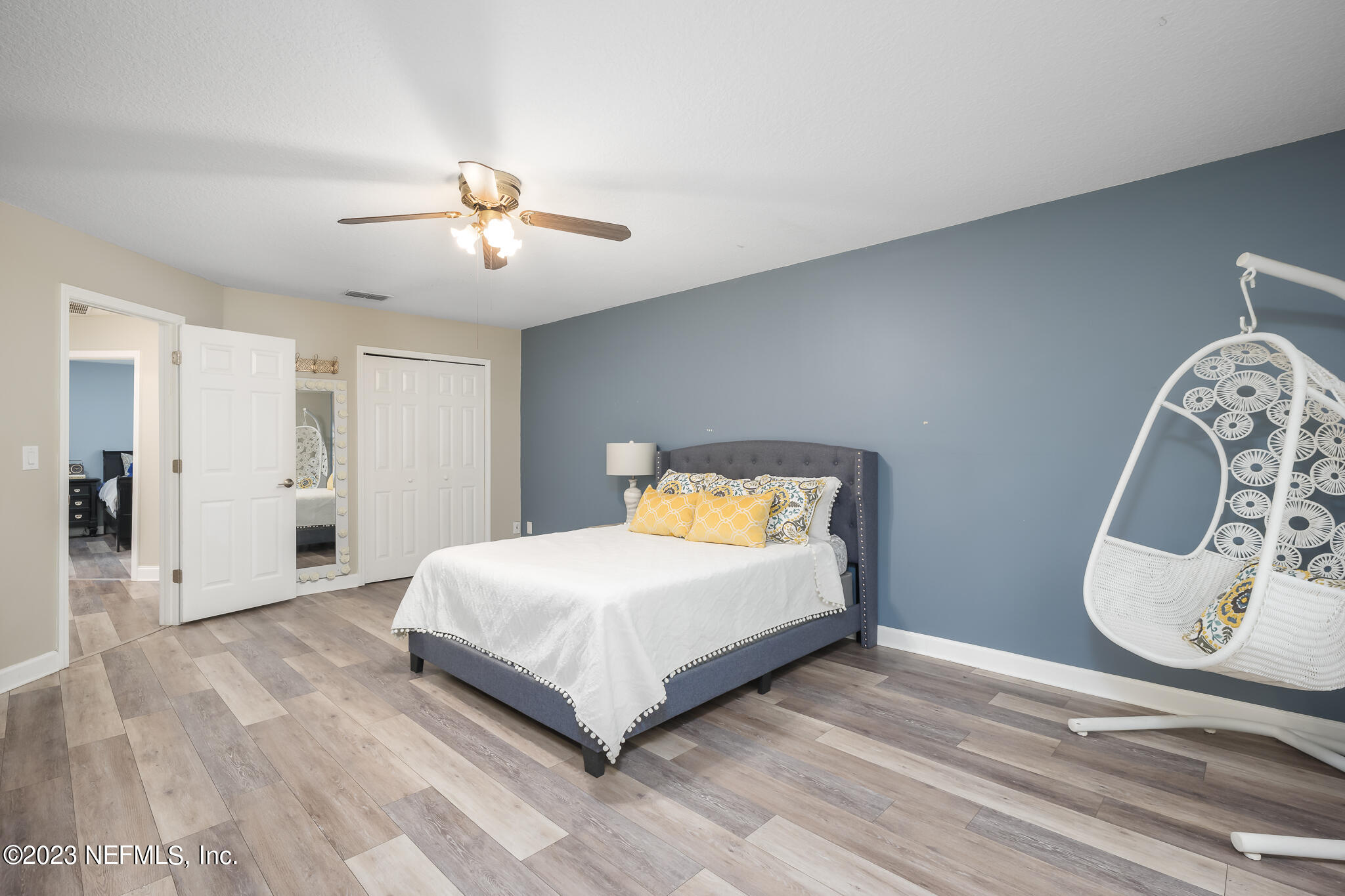 775 Camp Francis Johnson Road Orange Park, FL 32065 - Photo 32 of 41 a bedroom with a bed and a chandelier
