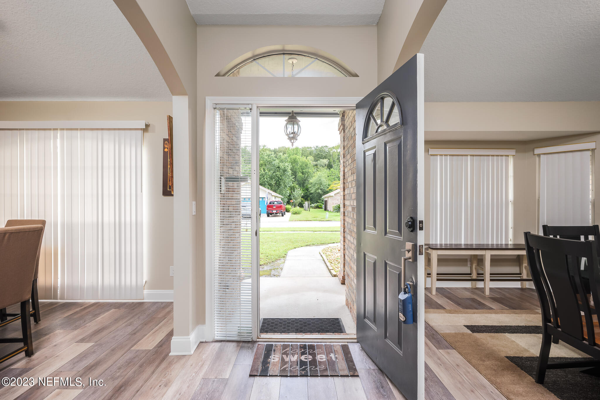 775 Camp Francis Johnson Road Orange Park, FL 32065 - Photo 6 of 41 a view of a hallway with wooden floor and dining room view