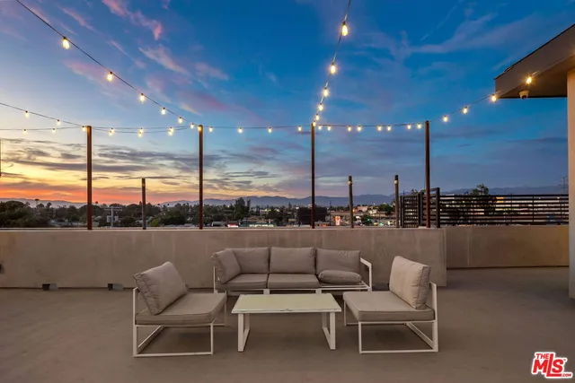 a terrace with outdoor seating and city view