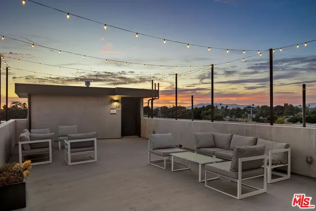 a living room with furniture a flat screen tv and a large window