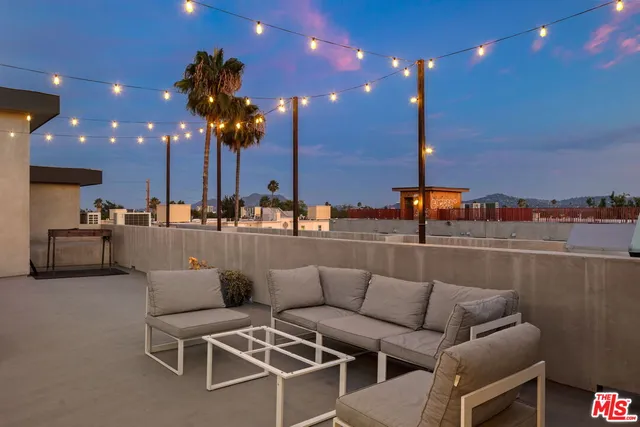 a view of a patio with a table and chairs