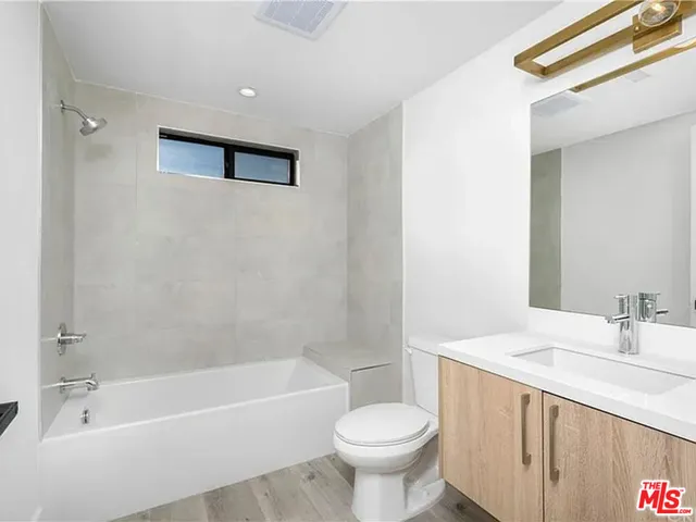 a bathroom with a sink a toilet and a bathtub