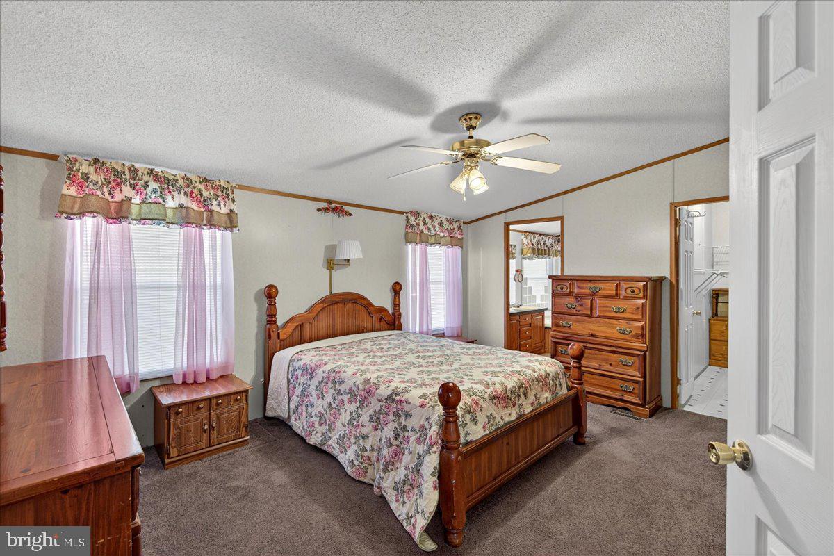 220 Chalklevel Road Louisa, VA 23093 - Photo 28 of 63 a bedroom with a bed and a chandelier