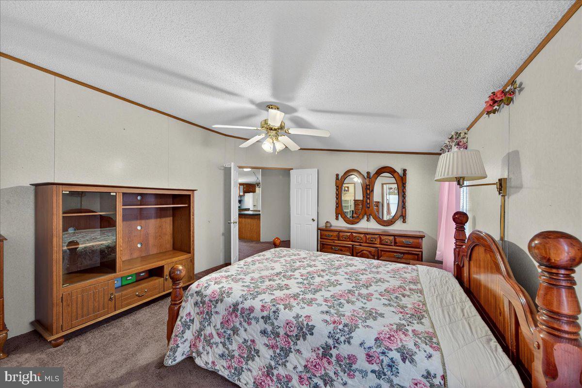 220 Chalklevel Road Louisa, VA 23093 - Photo 29 of 63 a bedroom with a bed and dresser with mirror