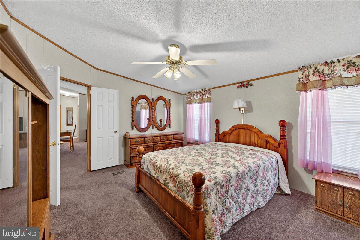 220 Chalklevel Road Louisa, VA 23093 - Photo 33 of 63 a bedroom with a bed and a chandelier