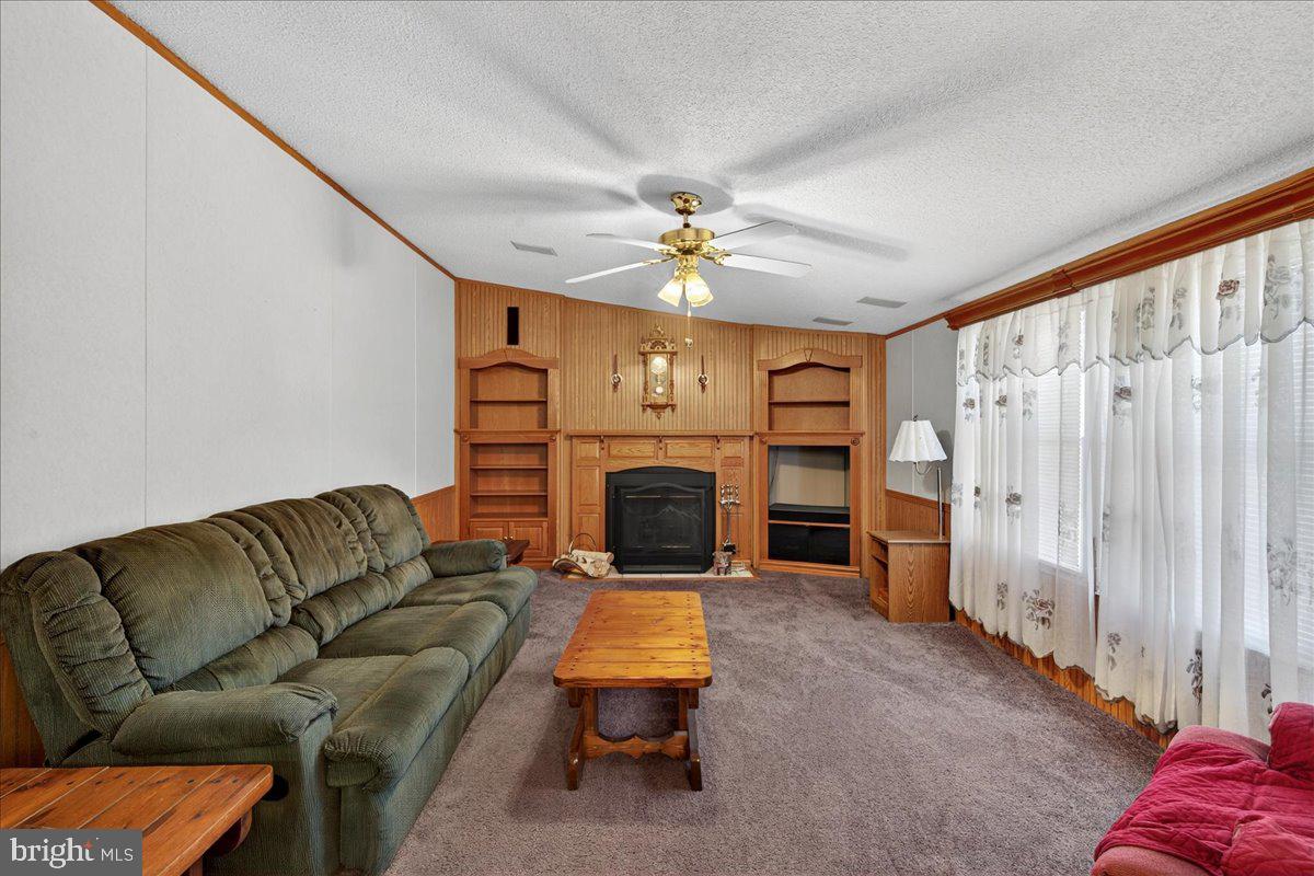 220 Chalklevel Road Louisa, VA 23093 - Photo 36 of 63 a living room with furniture a fireplace and a chandelier