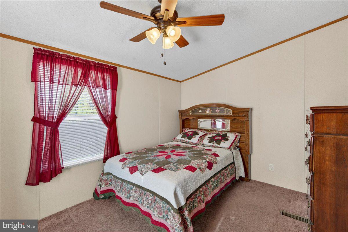 220 Chalklevel Road Louisa, VA 23093 - Photo 50 of 63 a bedroom with a bed and a chandelier