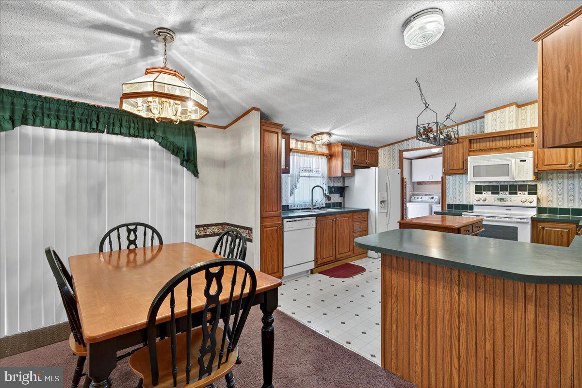 220 Chalklevel Road Louisa, VA 23093 - Photo 57 of 63 a kitchen with stainless steel appliances granite countertop a kitchen island a table and chairs