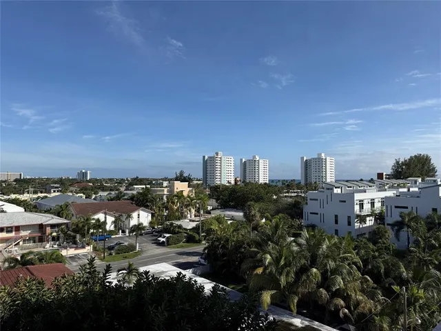 a kitchen with granite countertop a refrigerator and a sink