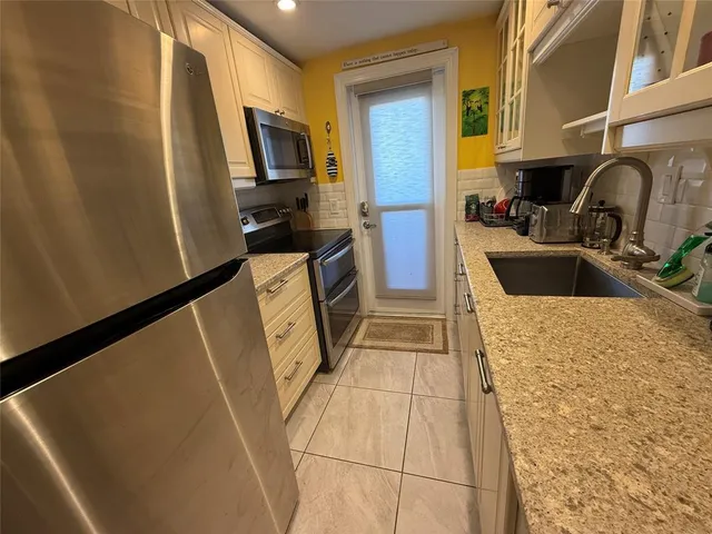 a room with a washing machine and a flat screen tv