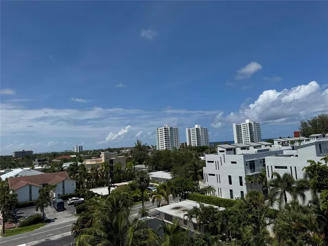 a city street lined with buildings and trees