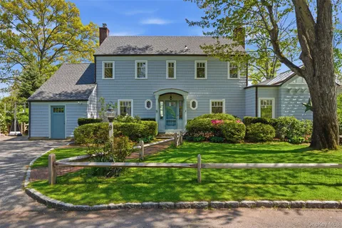 a front view of a house with a yard table and chairs