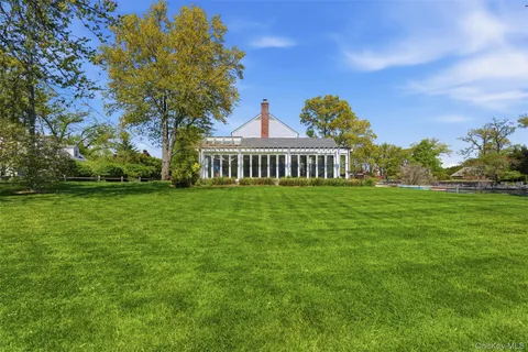 a view of a big yard next to a house with a big yard
