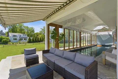 a front view of a house with a yard table and chairs