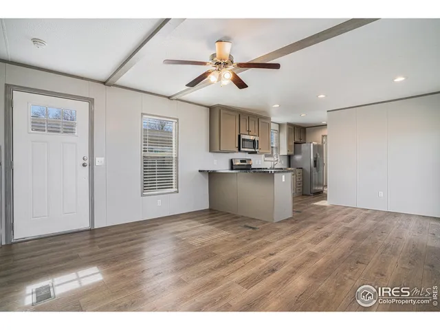 a view of a kitchen with a sink cabinets and wooden floor