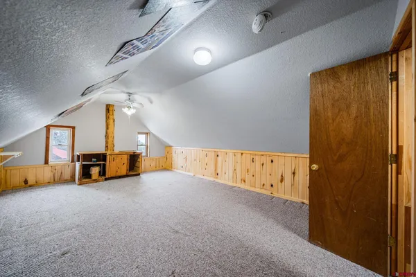 an aerial view of residential houses with outdoor space and ocean view