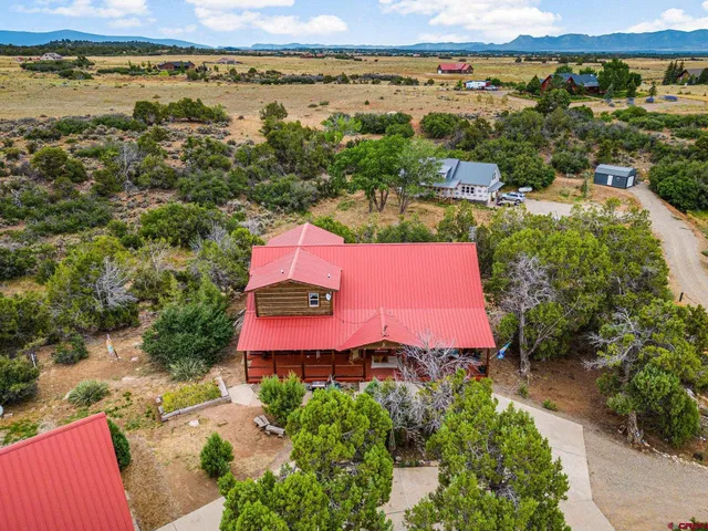 an aerial view of a house with a yard