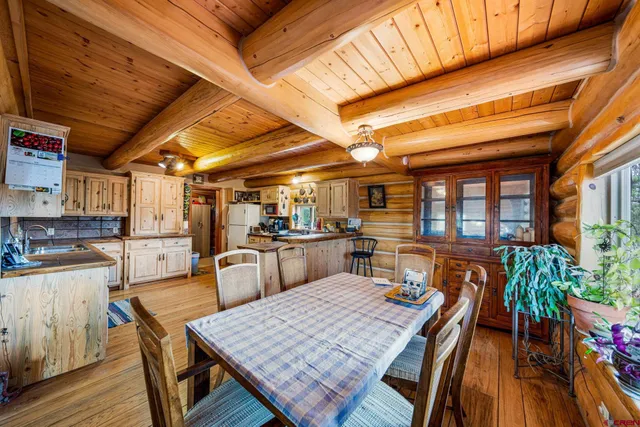 a dining room with furniture and wooden floor