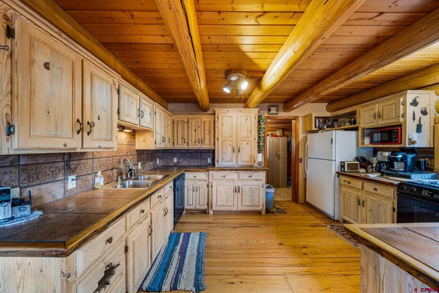 a kitchen with lots of counter space and stainless steel appliances