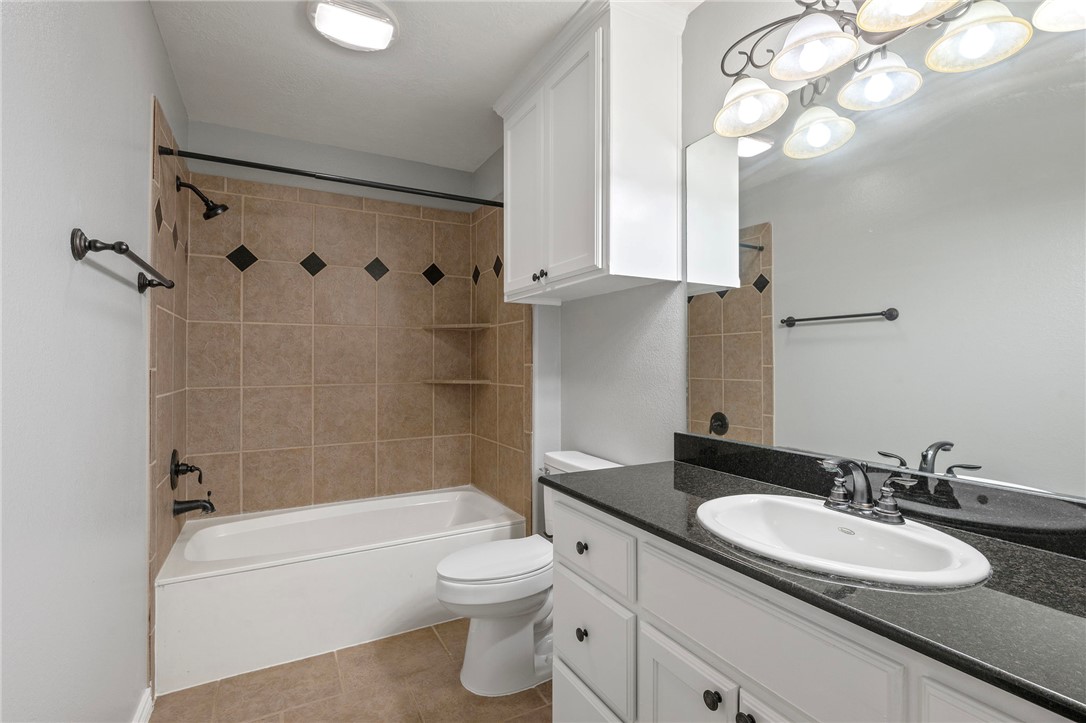 3304 Keefer Loop College Station, TX 77845 - Photo 15 of 21 a bathroom with a granite countertop sink a toilet and bathtub
