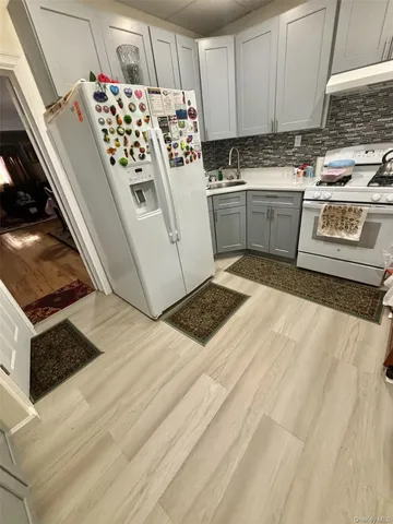 a kitchen with granite countertop a stove and a sink