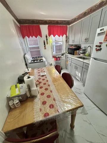 a view of a kitchen with dining table and chairs
