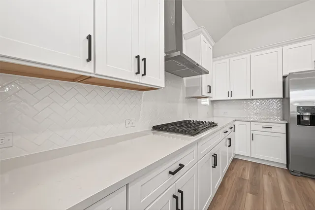 a kitchen with granite countertop white cabinets and white appliances