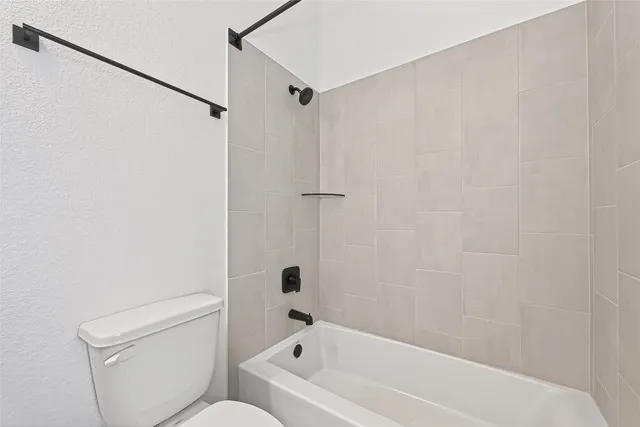 a bathroom with a bathtub and a toilet