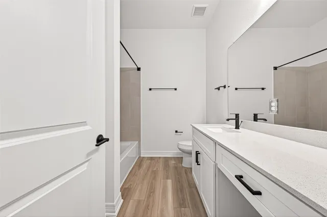 a view of a bathroom with a sink and a wooden floor
