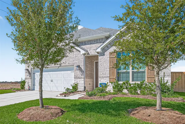 a front view of a house with a garden and plants
