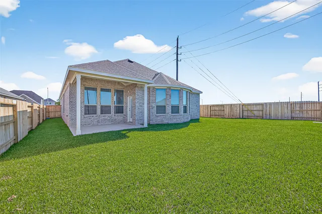 a view of a backyard with wooden fence