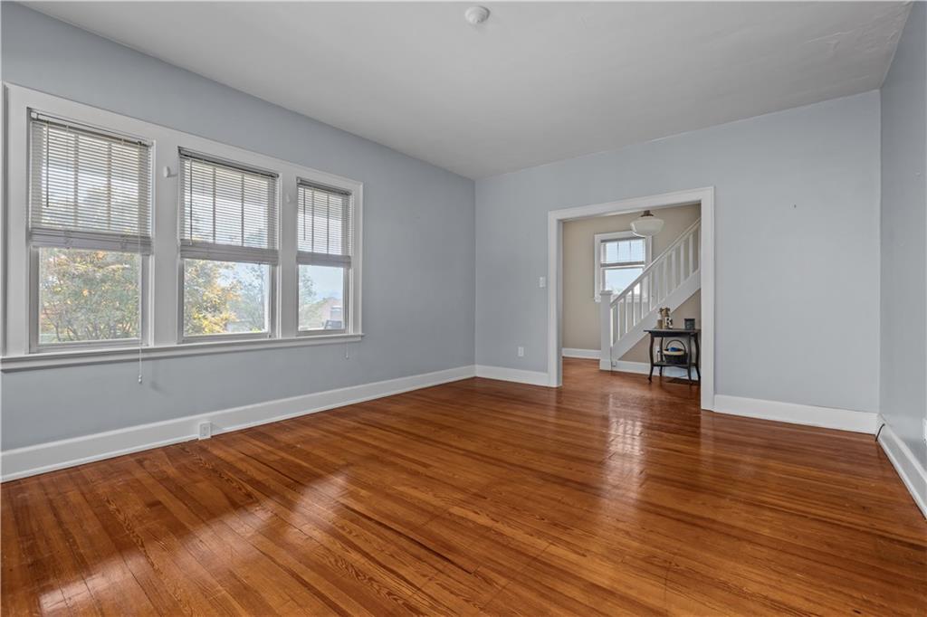 512 Regent Street Houston, PA 15342 - Photo 12 of 29 a view of empty room with wooden floor and fan