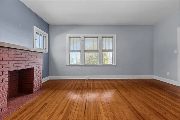 a spacious bedroom with a bed and a chandelier