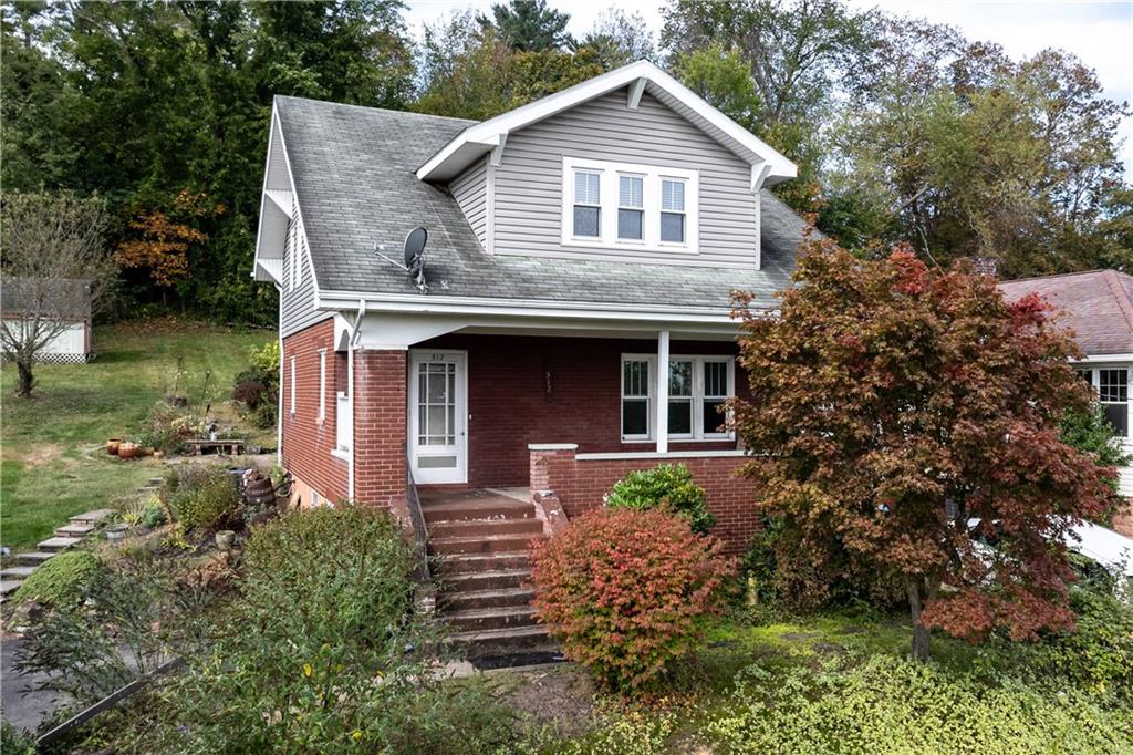 512 Regent Street Houston, PA 15342 - Photo 2 of 29 a front view of a house with garden