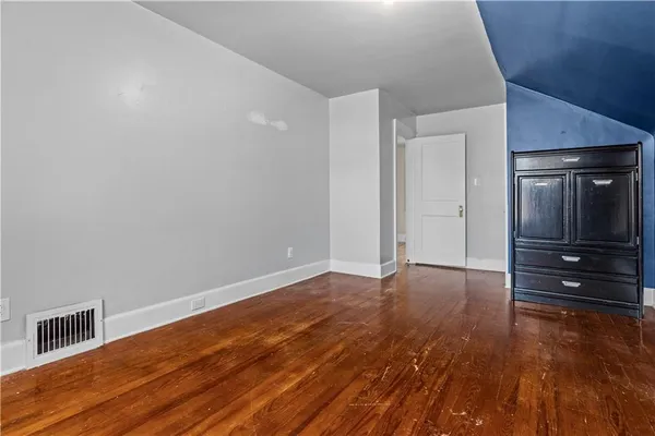 a view of an empty room and wooden floor