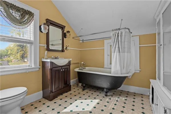 a yellow building in the middle of a yard