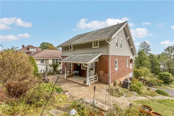 a view of a hallway with wooden floor and stairs