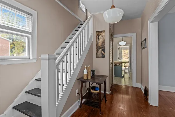 a view of empty room with wooden floor and fireplace