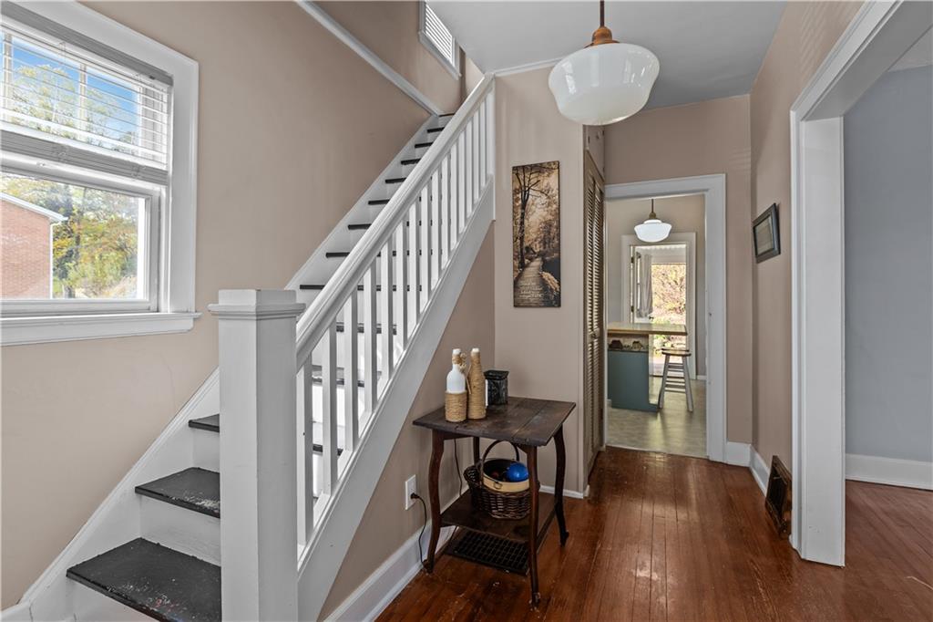 512 Regent Street Houston, PA 15342 - Photo 9 of 29 a view of a hallway with wooden floor and staircase