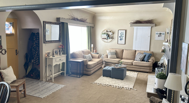 40 South State Street Scipio, UT 84656 - Photo 5 of 39 Living area featuring arched walkways, carpet, and a fireplace