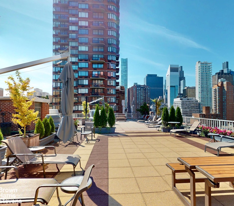 301 East 62nd Street, Unit 14B Manhattan, NY 10065 - Photo 10 of 14 a view of a city with tall buildings