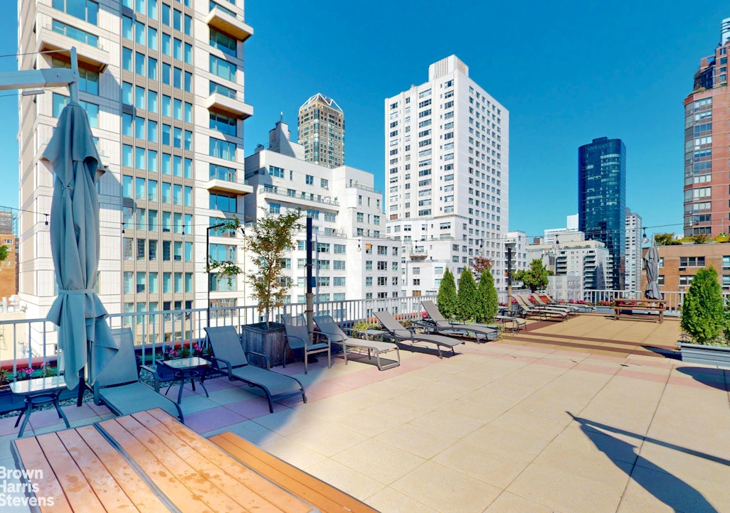 301 East 62nd Street, Unit 14B Manhattan, NY 10065 - Photo 13 of 14 a view of a city with tall buildings